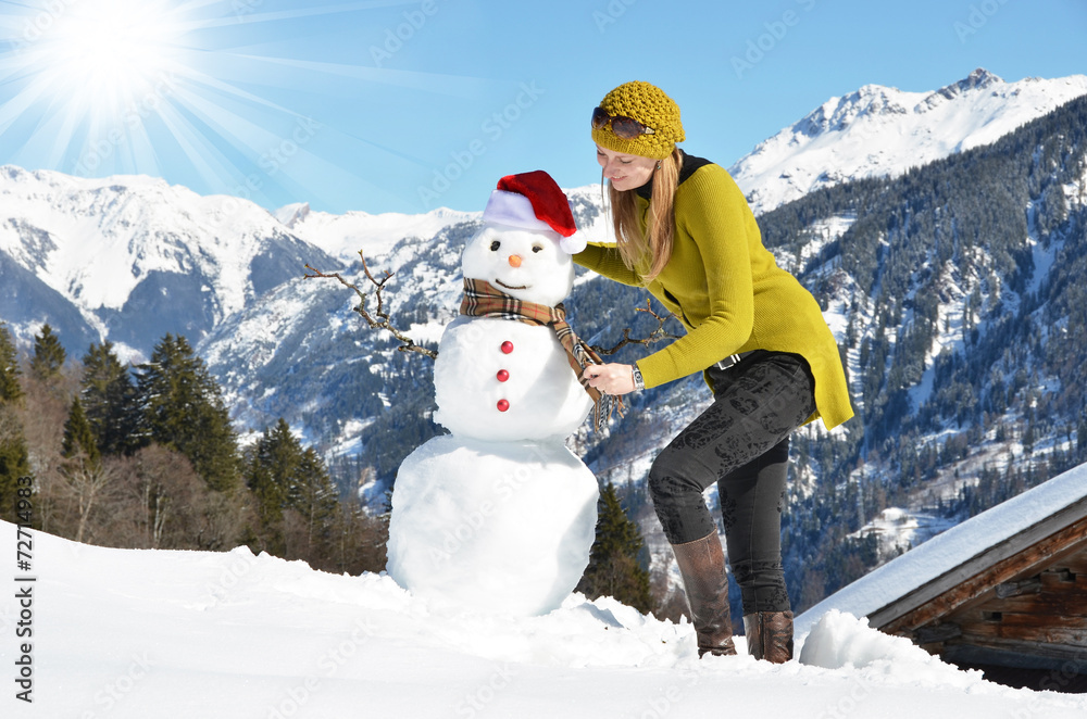 Girl decorating a snowman