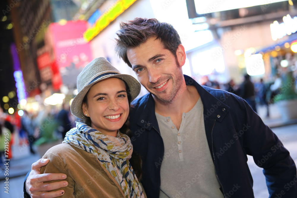 Couple standing in Time Square quarter by night Couple standing in Time Square quarter by night