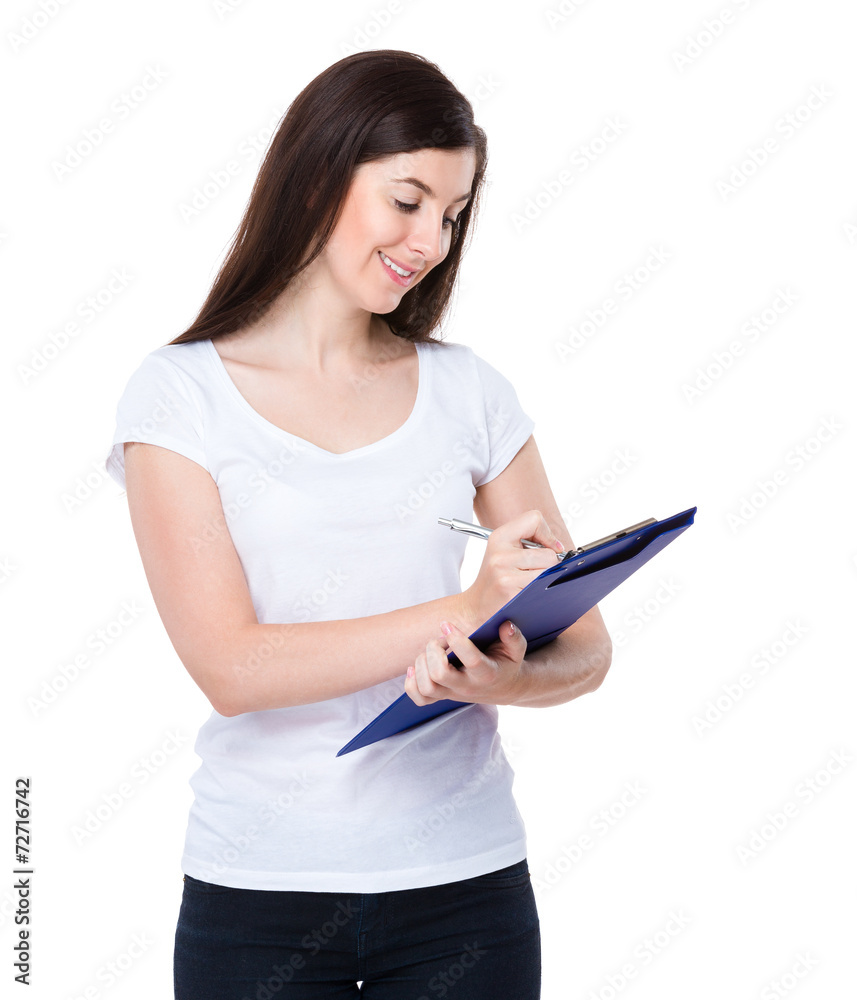 Caucasian woman write on clipboard Caucasian woman write on clipboard