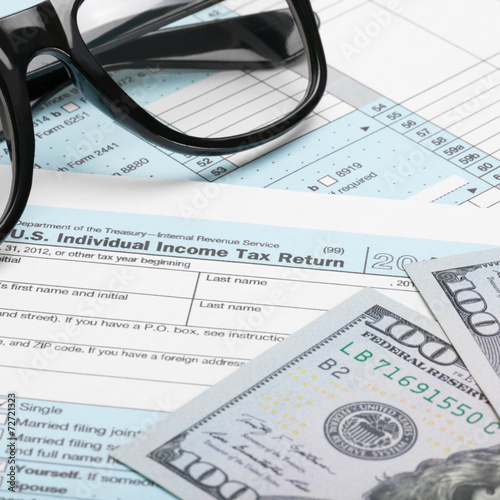 US Tax Form 1040 with dollars and glasses