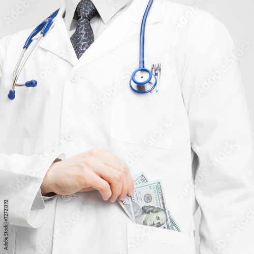 Doctor putting money into his pocket