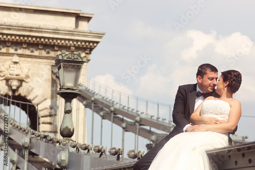 Bride and groom having fun on a bridge in Budapest, Hungary © hreniuca