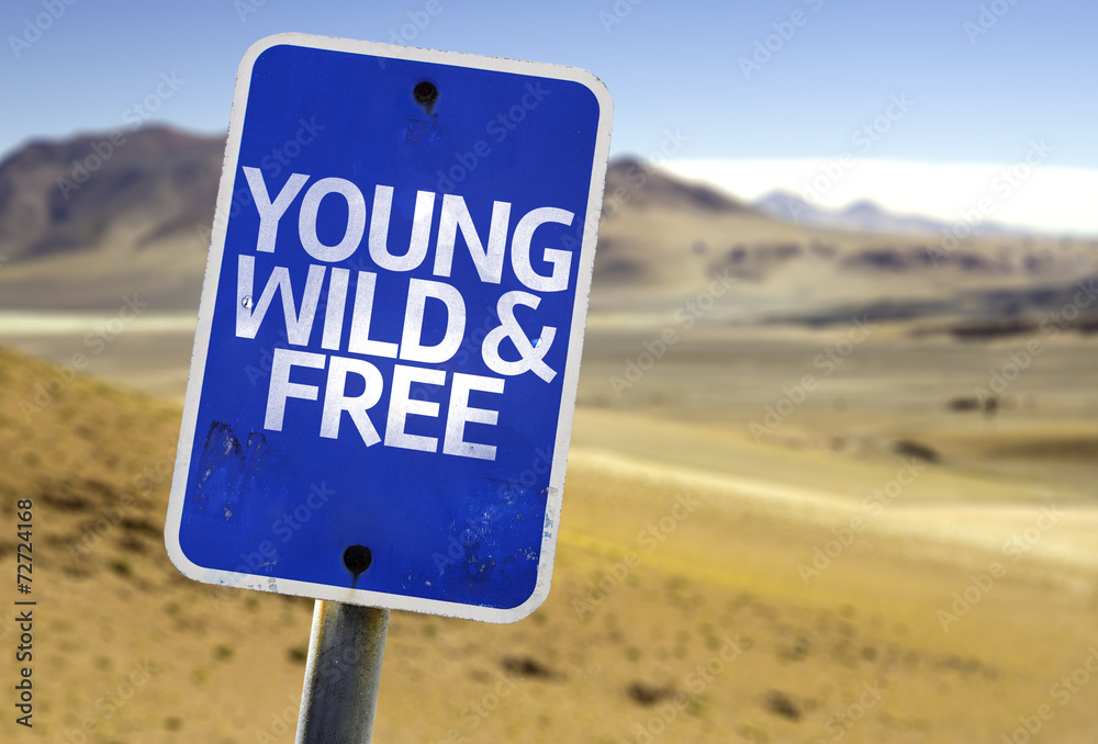 Young Wild & Free sign with a desert background