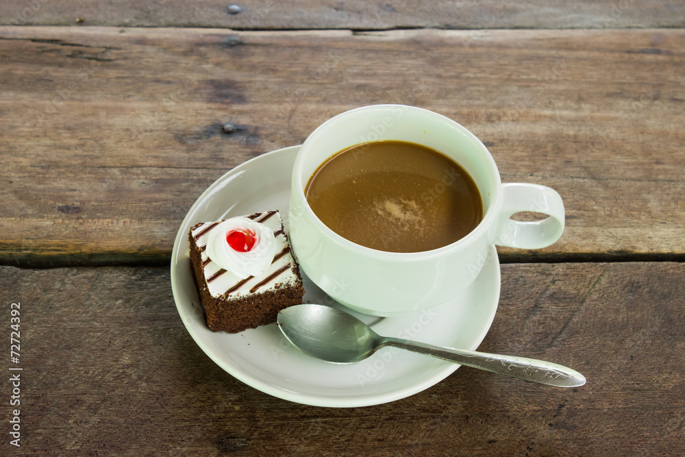 Coffee and cupcake  on a wood.