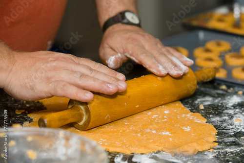 Baker rolling out dough