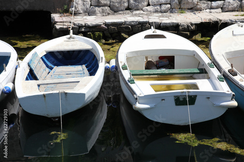 Old white wooden boats in Perast, Montenegro