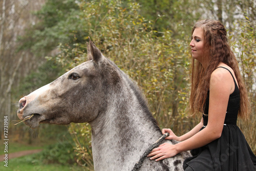 Amazing girl with long hair riding a horse © Zuzana Tillerova