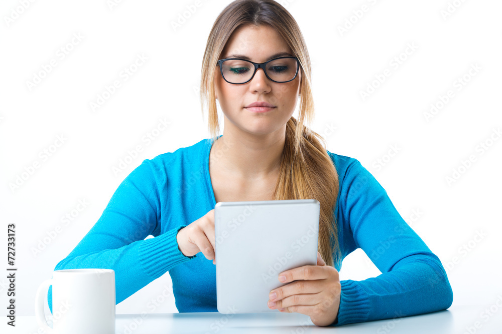Young smiling woman using digital tablet. Isolated on white.