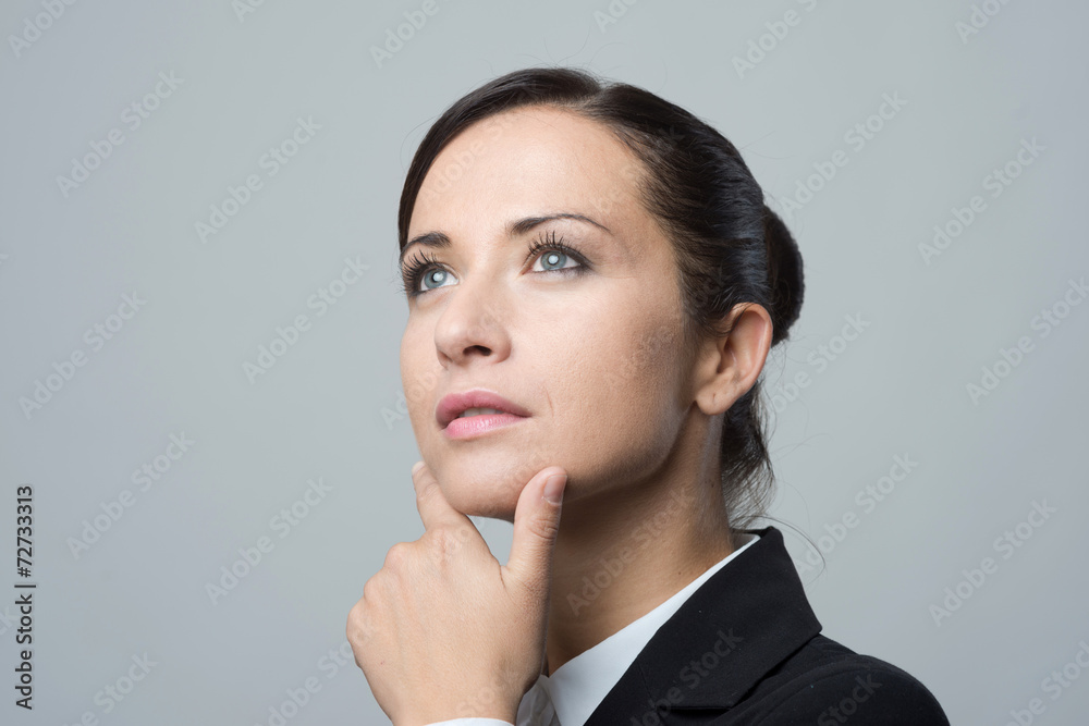 Pensive businesswoman with hand on chin Pensive businesswoman with hand on chin