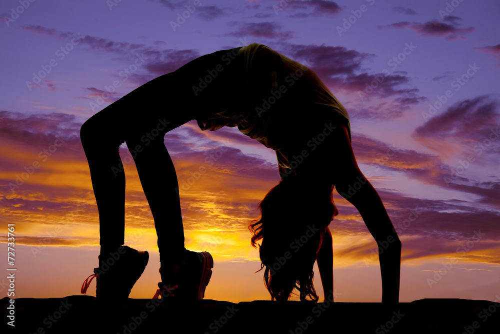 silhouette of woman doing back bend