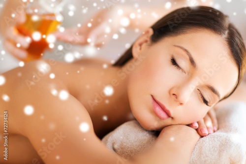 beautiful young woman in spa salon getting massage