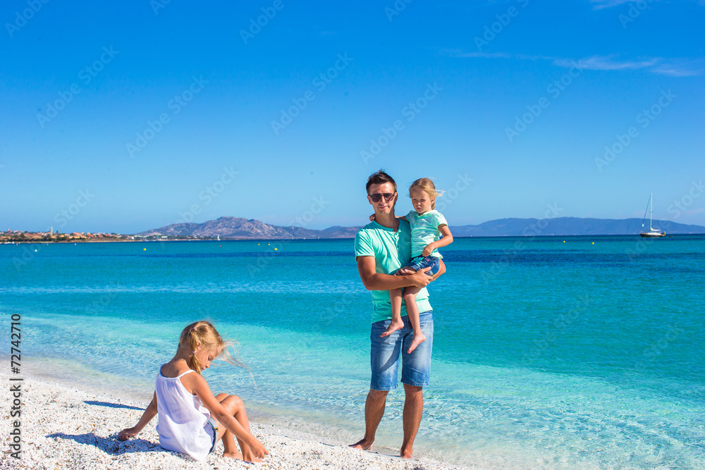 Family of three having fun during their tropical vacation