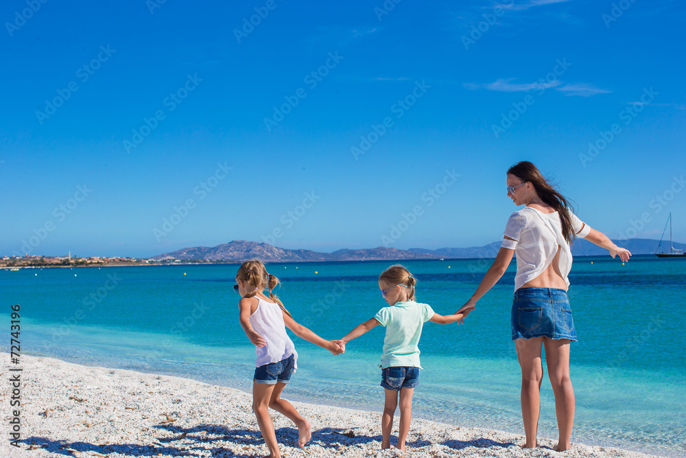 Young mother and her little daughters enjoying summer vacation