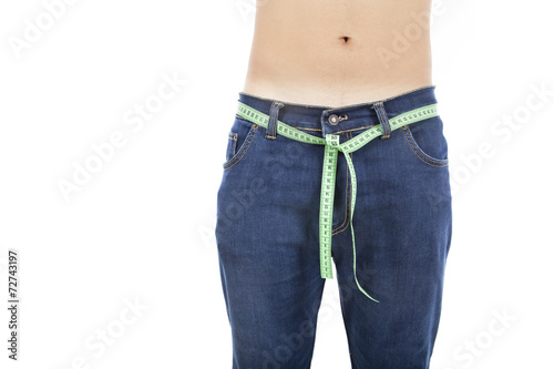 Young man on isolated background with a tape measure