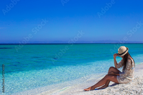 Young beautiful girl during summer vacation on white beach © travnikovstudio