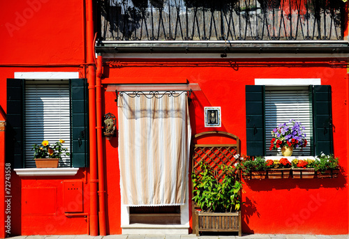 Venice, Burano island, painted red house, Italy
