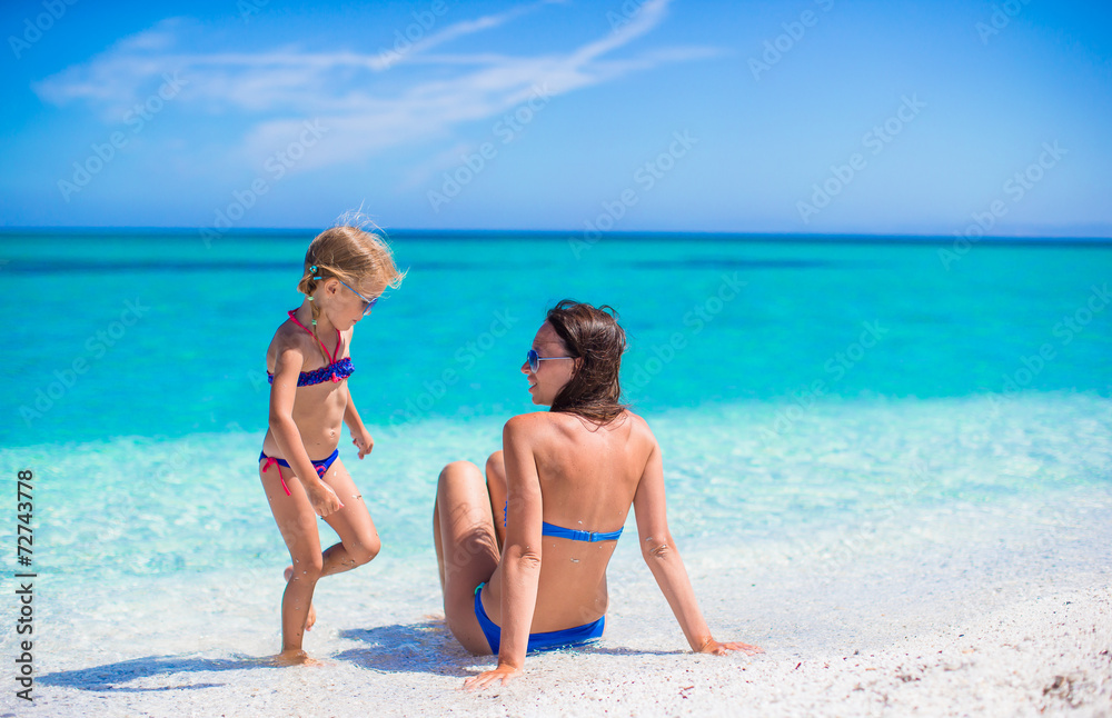 Mother and her little daughter on beach vacation