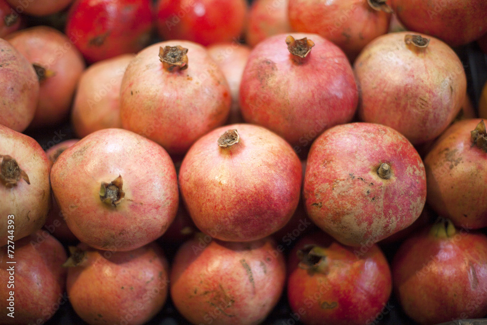 Fresh ripe pomegranate in raw on farmers market Fresh ripe pomegranate in raw on farmers market