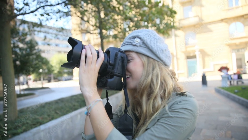 Young woman photographer taking picture in the street Young woman photographer taking picture in the street