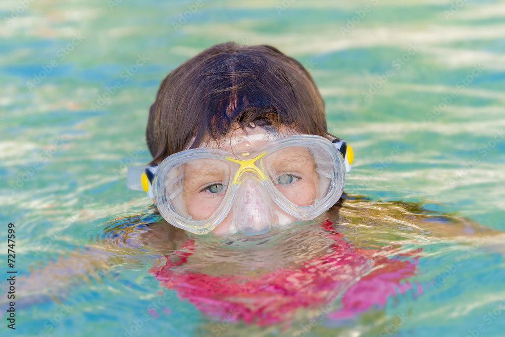 young child girl snorkelling in mask
