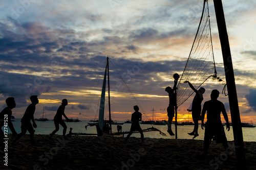 beach volleyball, sunset picture, silhouettes of players on sea