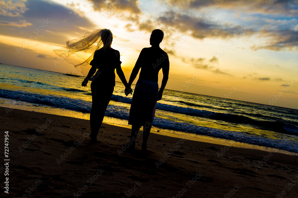 young loving couple on wedding day on tropical beach and sunset