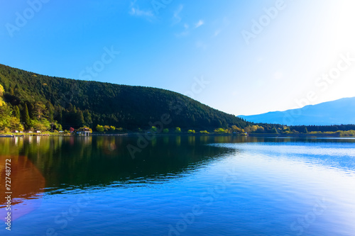 Sun shine and inverted Mount Fuji reflected in Lake Tanukiko