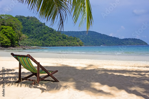 Tropical beach. Beach chairs on the white sand beach, foreground © MarinadeArt