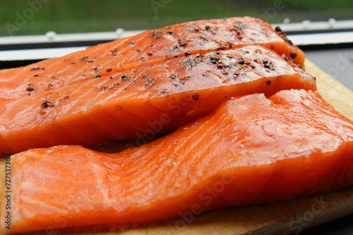 Marinated salmon fillets on the wood board