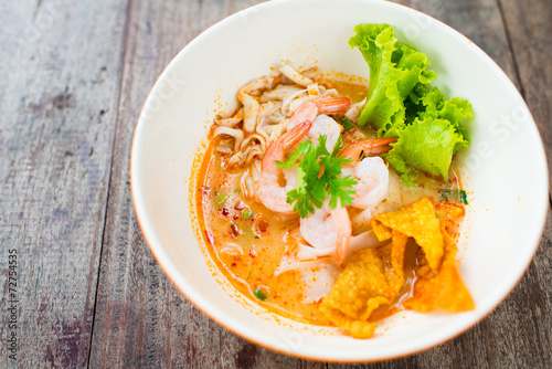 prawn mee or prawn noodles on wooden background photo