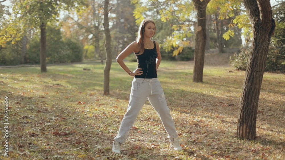 Beautiful girl doing exercises to warm up the muscles in the Beautiful girl doing exercises to warm up the muscles in the
