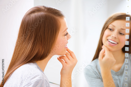 Teenage girl touching her face, enjoying her clean skin