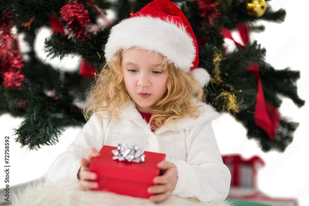Festive little girl holding a gift Festive little girl holding a gift