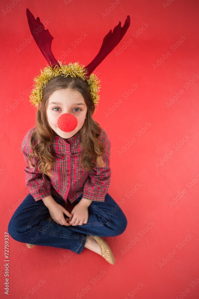 Festive little girl wearing red nose Festive little girl wearing red nose