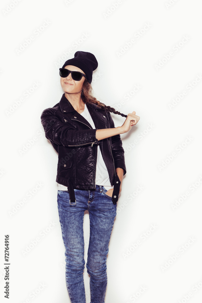 Woman in sunglasses and black leather jacket and beanie Woman in sunglasses and black leather jacket and beanie