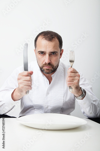 Man holding knife and fork Stock Photo | Adobe Stock