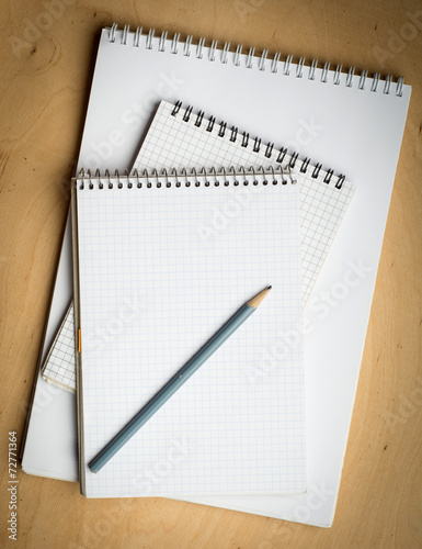notebook with pencile on a wooden photo