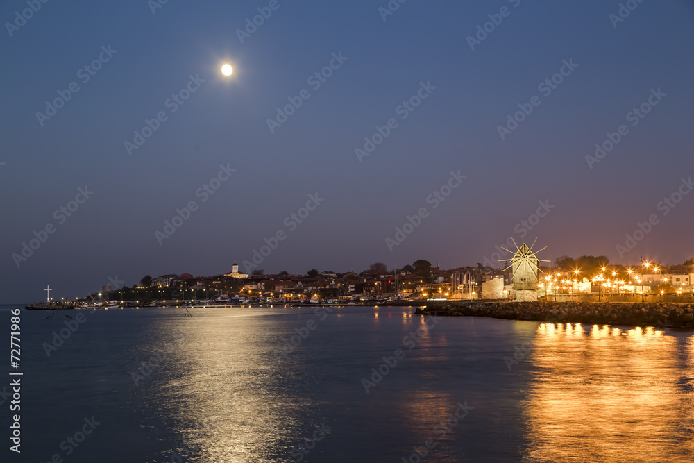 Full moon over the coastal city