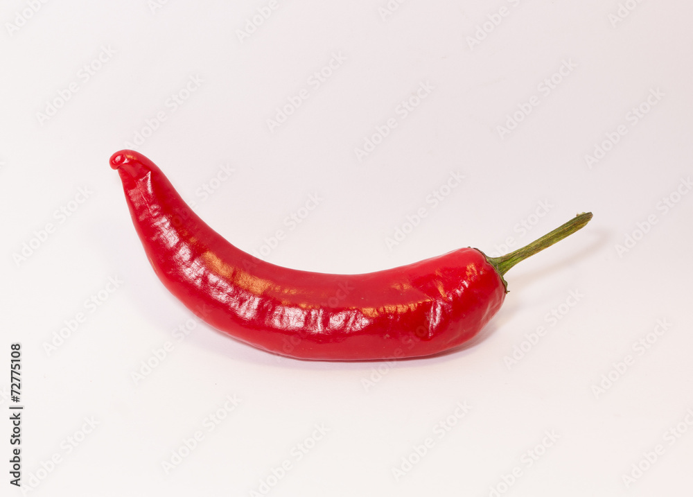 Strong red pepper on a white background