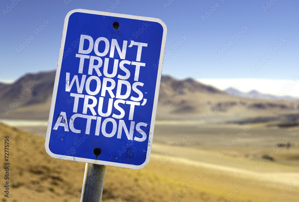 Don't Trust Words, Trust Actions sign with a desert background