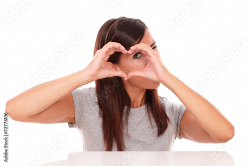 Alone latin woman looking through love sign