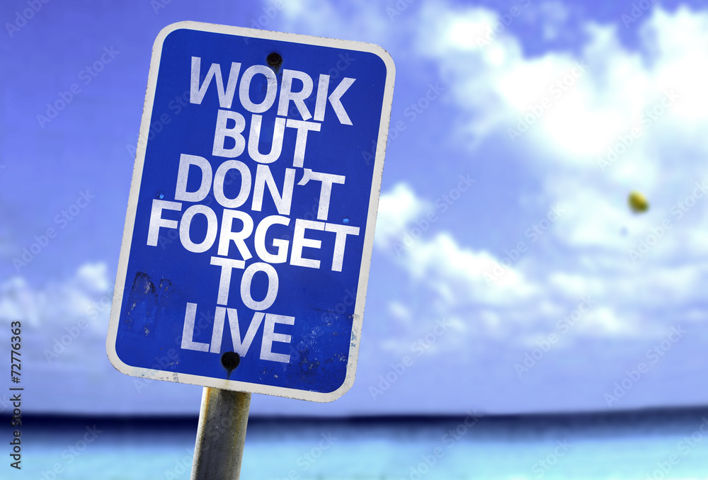 Work But Don't Forget to Live sign with a beach on background Work But Don't Forget to Live sign with a beach on background