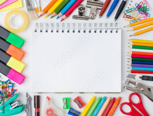 Blank notebook with colourful crayons
