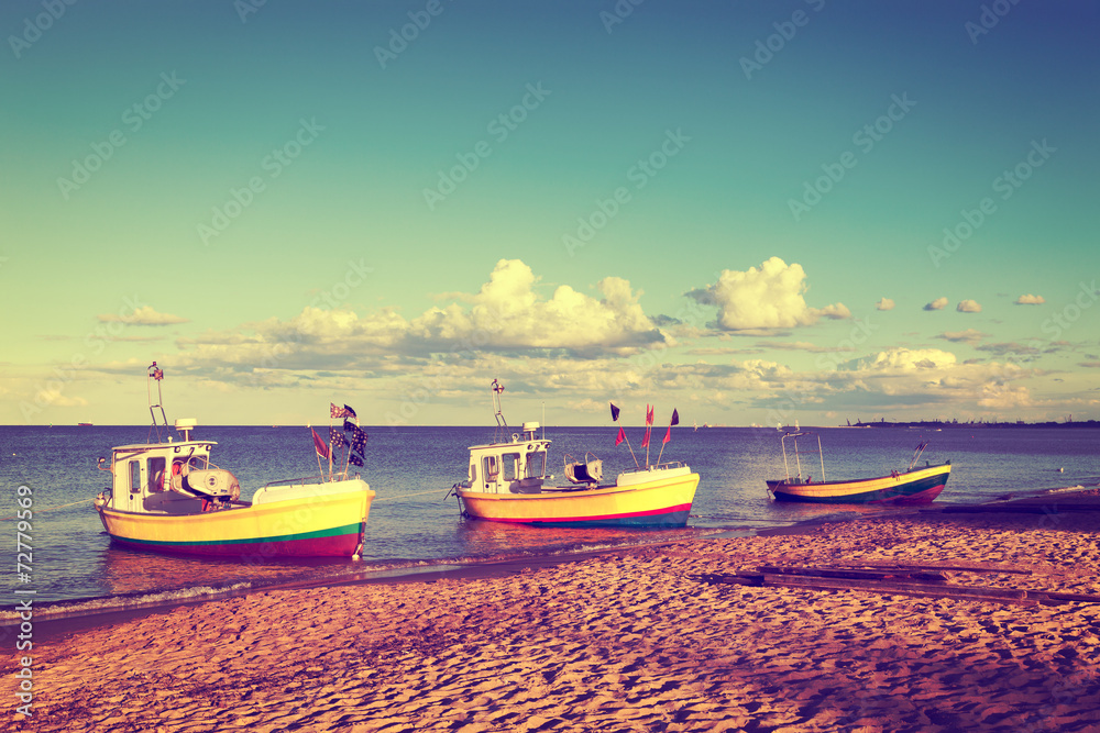 Fototapeta premium Fishing boats is moored in beach. Vintage toned photo.