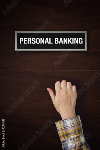 Hand is knocking on Personal banking door photo