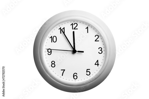 A single simple clock showing the time five to twelve