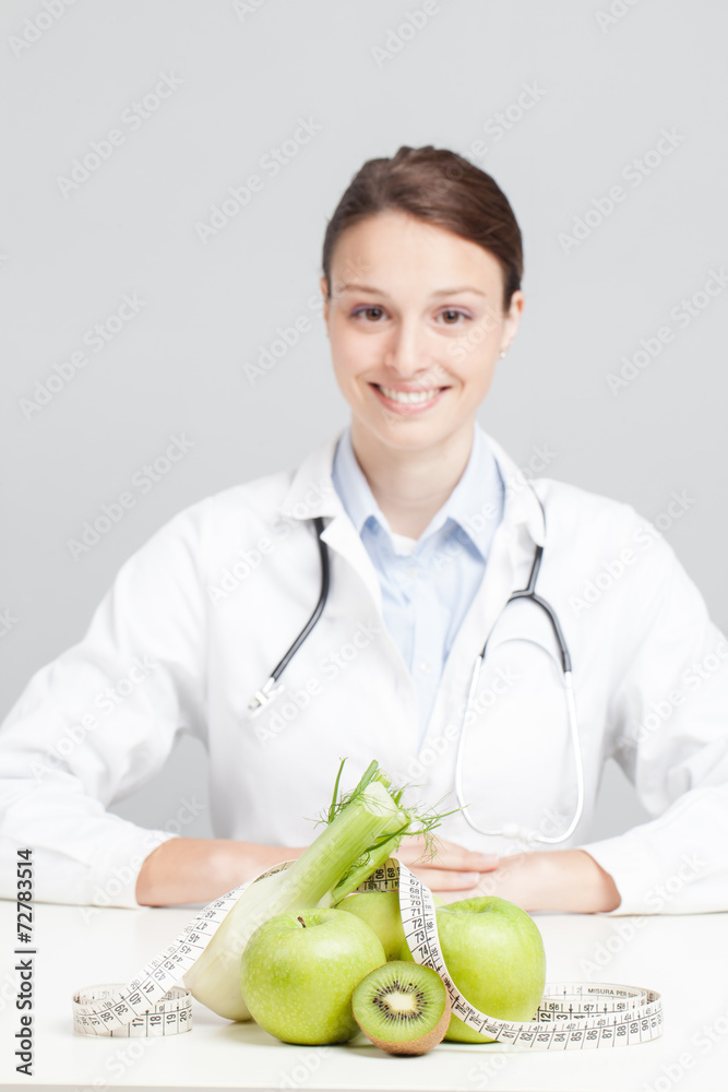 Nutritionist Doctor is writing a prescription. Focus on fruit Nutritionist Doctor is writing a prescription. Focus on fruit