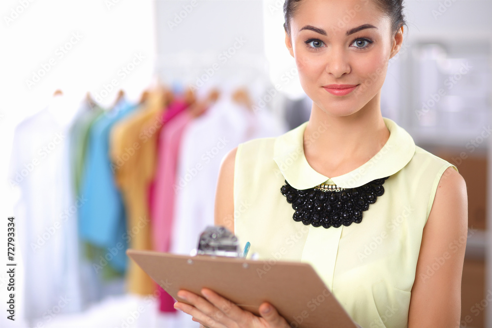 Modern young fashion designer working at studio. Modern young fashion designer working at studio.