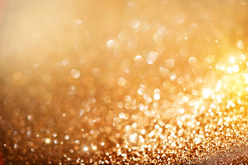 Christmas gold background. Golden holiday glowing background