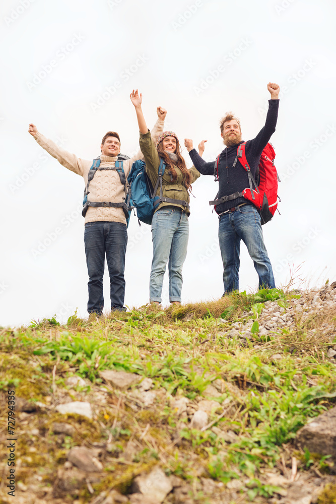 group of smiling friends with backpacks hiking group of smiling friends with backpacks hiking